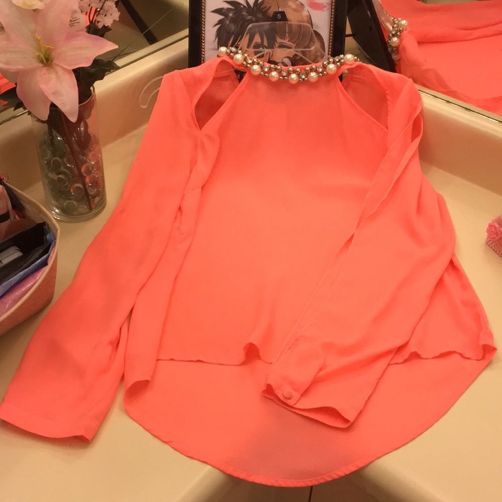coral blouse with pearl neck detail